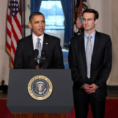 He is standing on the left of Obama as Obama is speaking standing behind podium.